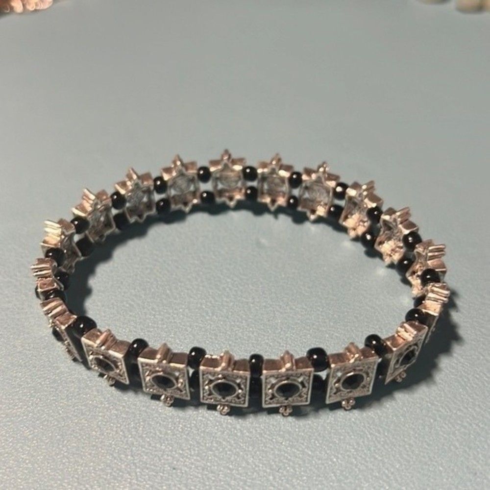 Handcrafted Silver tone stretch bracelet with black bead.